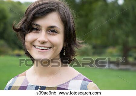Portrait of young woman in park View Large Photo Image Stock Image - Portrait of young woman in park. Fotosearch