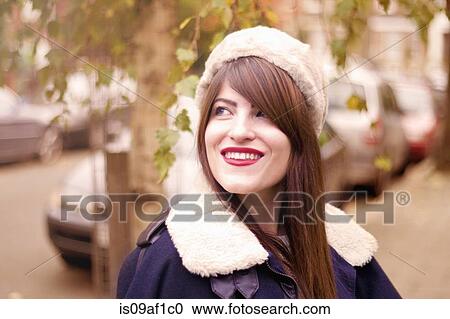 Stock Image - Portrait of young woman wearing winter clothing. Fotosearch