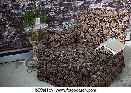 Still life of armchair and book in conservatory View Large Photo Image Stock Photo - Still life of armchair and book in conservatory. Fotosearch
