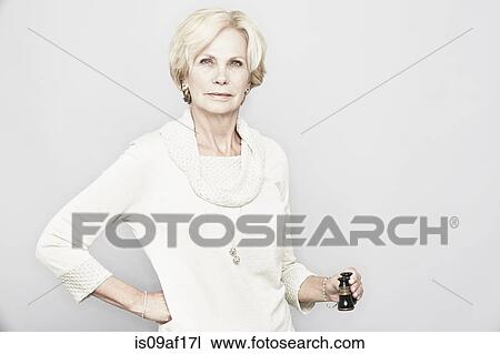 Studio portrait of senior woman holding binoculars View Large Photo Image Stock Image - Studio portrait of senior woman holding binoculars. Fotosearch