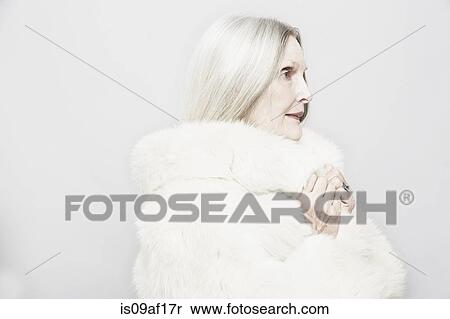 Studio portrait of senior woman in white fur coat View Large Photo Image Stock Photography - Studio portrait of senior woman in white fur coat. Fotosearch