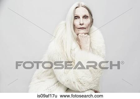 Studio portrait of senior woman with hand on chin View Large Photo Image Stock Photograph - Studio portrait of senior woman with hand on chin. Fotosearch