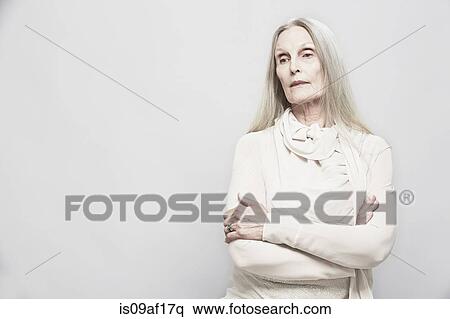 Studio portrait of senior woman with arms crossed View Large Photo Image Stock Photography - Studio portrait of senior woman with arms crossed. Fotosearch