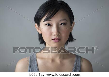 Studio portrait of serious young woman View Large Photo Image Stock Photo - Studio portrait of serious young woman. Fotosearch