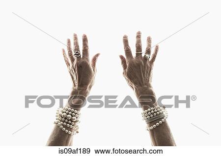 Stock Photo - Studio shot of mature woman's reaching hands. Fotosearch