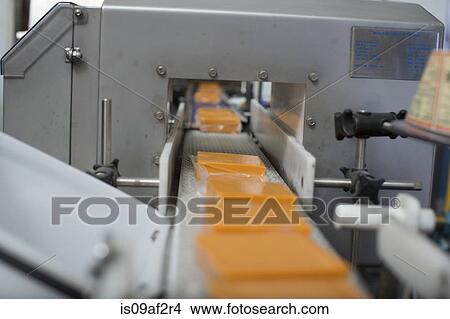 Vegan cheese on conveyor belt in warehouse View Large Photo Image Picture - Vegan cheese on conveyor belt in warehouse. Fotosearch