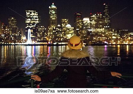 Woman and Seattle skyline at night, Washington, USA View Large Photo Image Stock Image - Woman and Seattle skyline at night, Washington, USA. Fotosearch