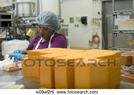 Woman packaging vegan cheese in warehouse View Large Photo Image Stock Photograph - Woman packaging vegan cheese in warehouse. Fotosearch