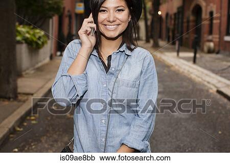 Stock Image - Woman talking on cellular phone. Fotosearch