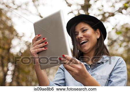 Woman using digital tablet View Large Photo Image Stock Photograph - Woman using digital tablet. Fotosearch