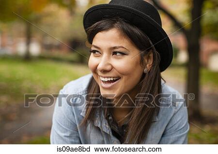Woman with hat in park View Large Photo Image Stock Image - Woman with hat in park. Fotosearch