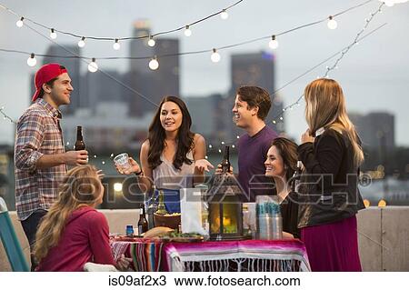 Young adult friends having fun at barbeque View Large Photo Image Stock Image - Young adult friends having fun at barbeque. Fotosearch