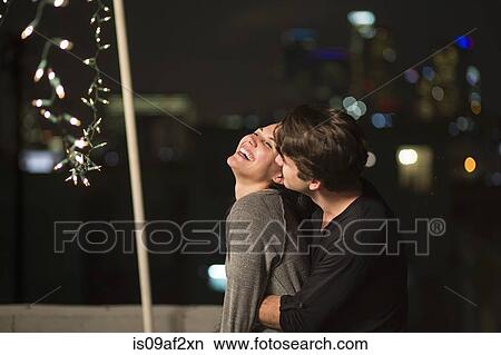 Young couple embracing at rooftop party View Large Photo Image Picture - Young couple embracing at rooftop party. Fotosearch