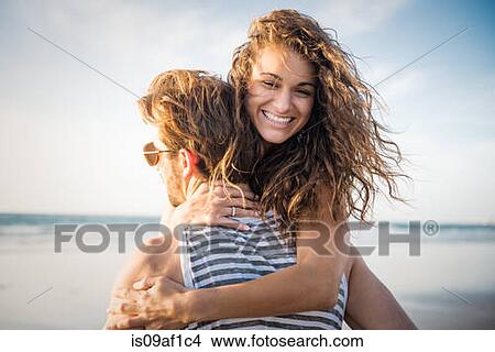 Young couple hugging in San Diego beach View Large Photo Image Picture - Young couple hugging in San Diego beach. Fotosearch