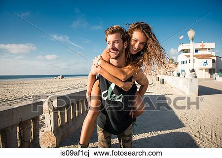 Young man giving girlfriend a piggy back at San Diego beach View Large Photo Image Stock Image - Young man giving girlfriend a piggy back at San Diego beach. Fotosearch