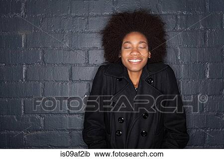 Young woman by black brick wall wearing black jacket View Large Photo Image Stock Image - Young woman by black brick wall wearing black jacket. Fotosearch