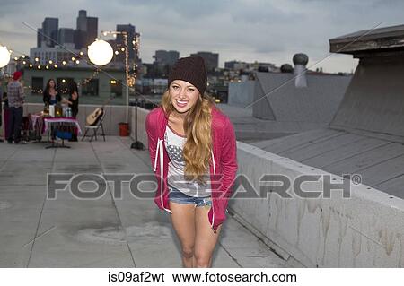 Young woman in wool hat at rooftop barbecue View Large Photo Image Stock Photograph - Young woman in wool hat at rooftop barbecue. Fotosearch