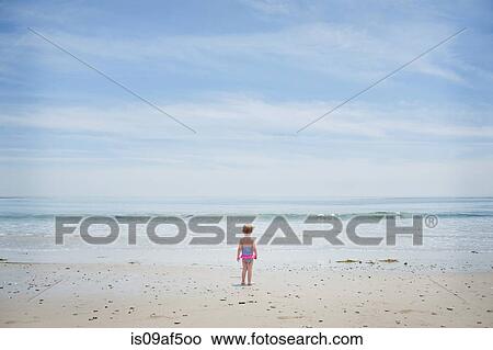 Apprehensive female toddler watching the sea View Large Photo Image Picture - Apprehensive female toddler watching the sea. Fotosearch