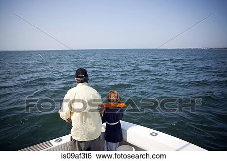 Stock Photograph - Boy and grandfather fishing from boat, Falmouth, Massachusetts, USA. Fotosearch