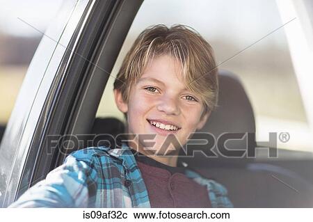 Boy smiling in car View Large Photo Image Stock Image - Boy smiling in car. Fotosearch