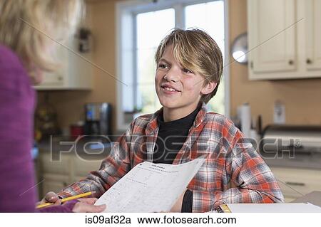 Stock Image - Boy smiling in kitchen. Fotosearch