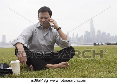 Stock Image - Businessman using cellular phone, Hoboken, New Jersey, USA. Fotosearch