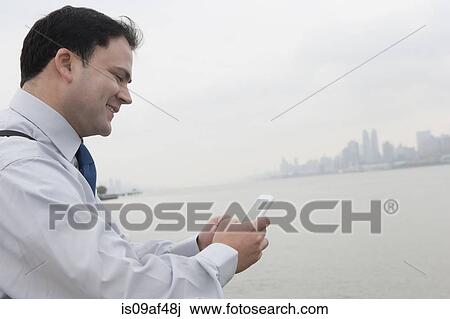 Businessman using cellular phone, Hoboken, New Jersey, USA View Large Photo Image Stock Image - Businessman using cellular phone, Hoboken, New Jersey, USA. Fotosearch