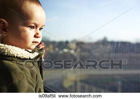 Close up of baby boy staring out of window View Large Photo Image Stock Image - Close up of baby boy staring out of window. Fotosearch