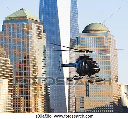 Picture - Close up of helicopter and office buildings, New York, USA. Fotosearch