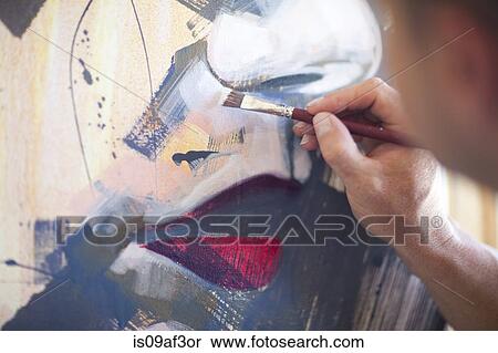 Stock Photography - Close up of mature male artist working on canvas. Fotosearch