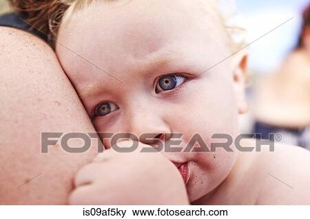 Close up of mother and male toddler sucking his thumb View Large Photo Image Stock Photo - Close up of mother and male toddler sucking his thumb. Fotosearch