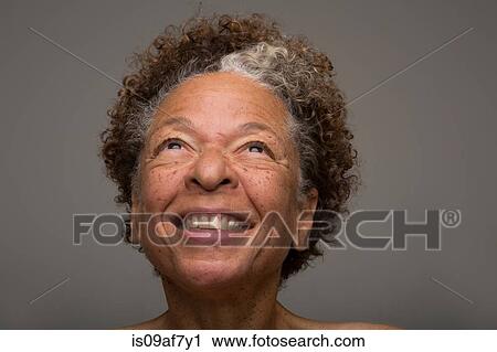 Stock Image - Close up studio portrait of smiling senior woman. Fotosearch