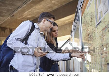 Picture - Couple looking at subway map, Los Angeles, California, USA. Fotosearch