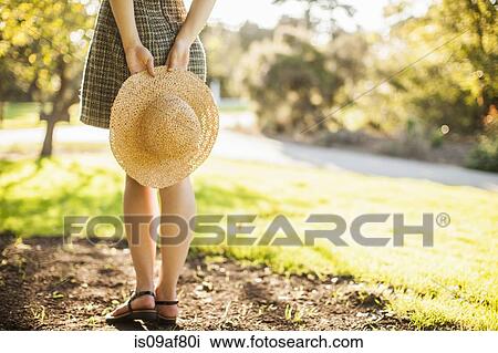 Cropped image of teenage girl holding sunhat behind her back View Large Photo Image Stock Image - Cropped image of teenage girl holding sunhat behind her back. Fotosearch