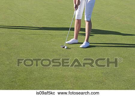 Stock Image - Cropped shot of young female golfer. Fotosearch