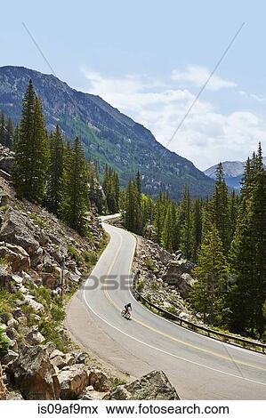 Cyclist on winding highway, Aspen, Colorado, USA View Large Photo Image Stock Photo - Cyclist on winding highway, Aspen, Colorado, USA. Fotosearch