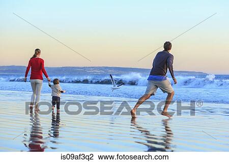 Stock Image - Family and toddler son playing on beach, San Diego, California, USA. Fotosearch