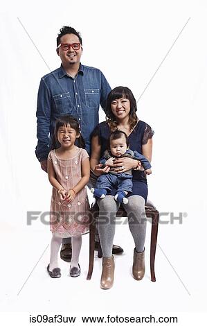 Family portrait of mid adult couple with daughter and baby boy View Large Photo Image Stock Photo - Family portrait of mid adult couple with daughter and baby boy. Fotosearch