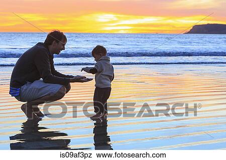 Father and toddler son playing on beach, San Diego, California, USA View Large Photo Image Stock Photo - Father and toddler son playing on beach, San Diego, California, USA. Fotosearch