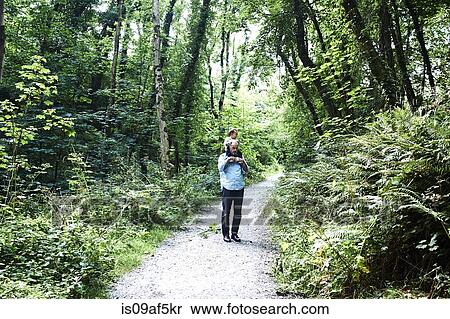 Father carrying baby son on shoulders along country lane View Large Photo Image Stock Photography - Father carrying baby son on shoulders along country lane. Fotosearch