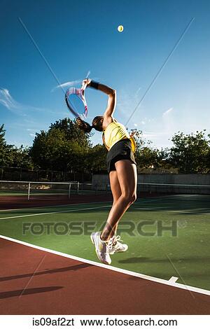 Female tennis player hitting ball View Large Photo Image Stock Photograph - Female tennis player hitting ball. Fotosearch