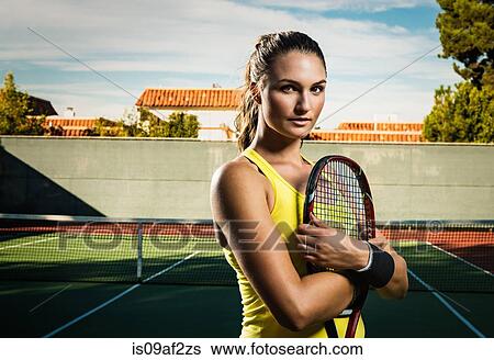 Female tennis player holding racket View Large Photo Image Stock Photograph - Female tennis player holding racket. Fotosearch