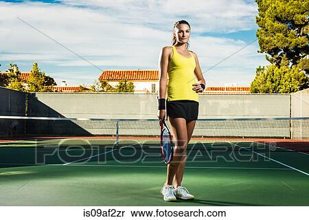 Female tennis player on court holding racket View Large Photo Image Stock Photography - Female tennis player on court holding racket. Fotosearch