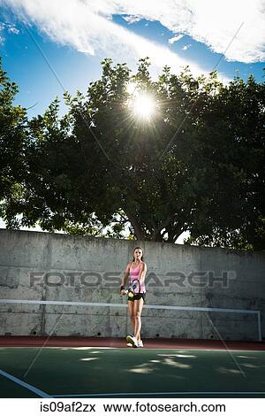 Stock Photo - Female tennis player serving ball. Fotosearch