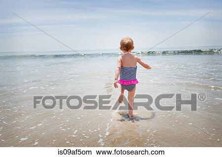 Female toddler running into the sea View Large Photo Image Picture - Female toddler running into the sea. Fotosearch