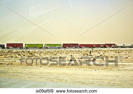 Freight locomotive moving through arid landscape, California, USA View Large Photo Image Stock Photo - Freight locomotive moving through arid landscape, California, USA. Fotosearch