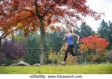 Stock Photo - Girl jogging in forest. Fotosearch