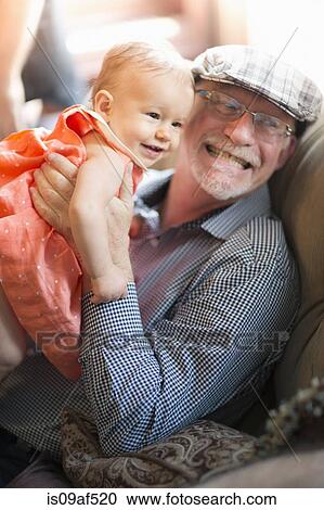 Grandfather holding granddaughter View Large Photo Image Stock Image - Grandfather holding granddaughter. Fotosearch