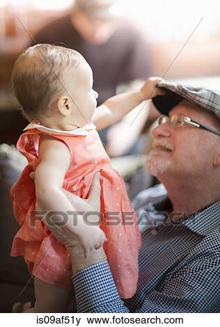 Grandfather holding granddaughter View Large Photo Image Stock Photo - Grandfather holding granddaughter. Fotosearch