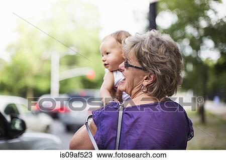 Grandmother holding granddaughter View Large Photo Image Stock Image - Grandmother holding granddaughter. Fotosearch